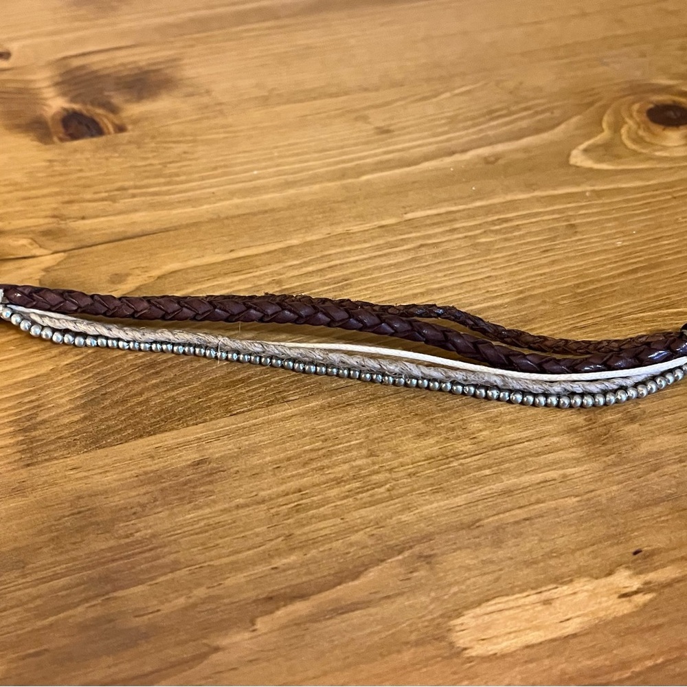 5 strand leather bracelet with silver metal piece that fits through loop closure